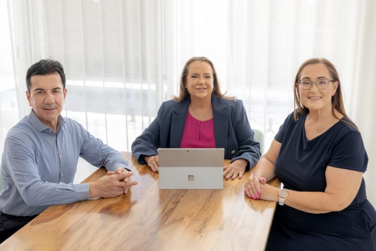 Perth Strata Co team seated around a meeting table