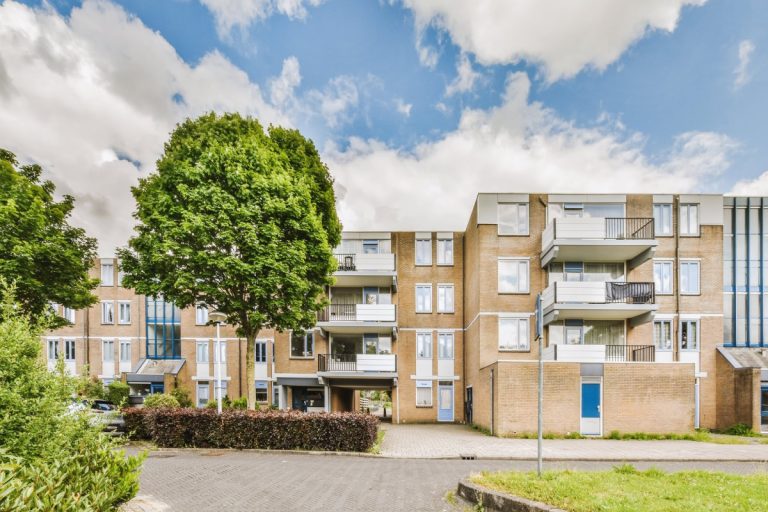 Modern apartment building with balconies and trees