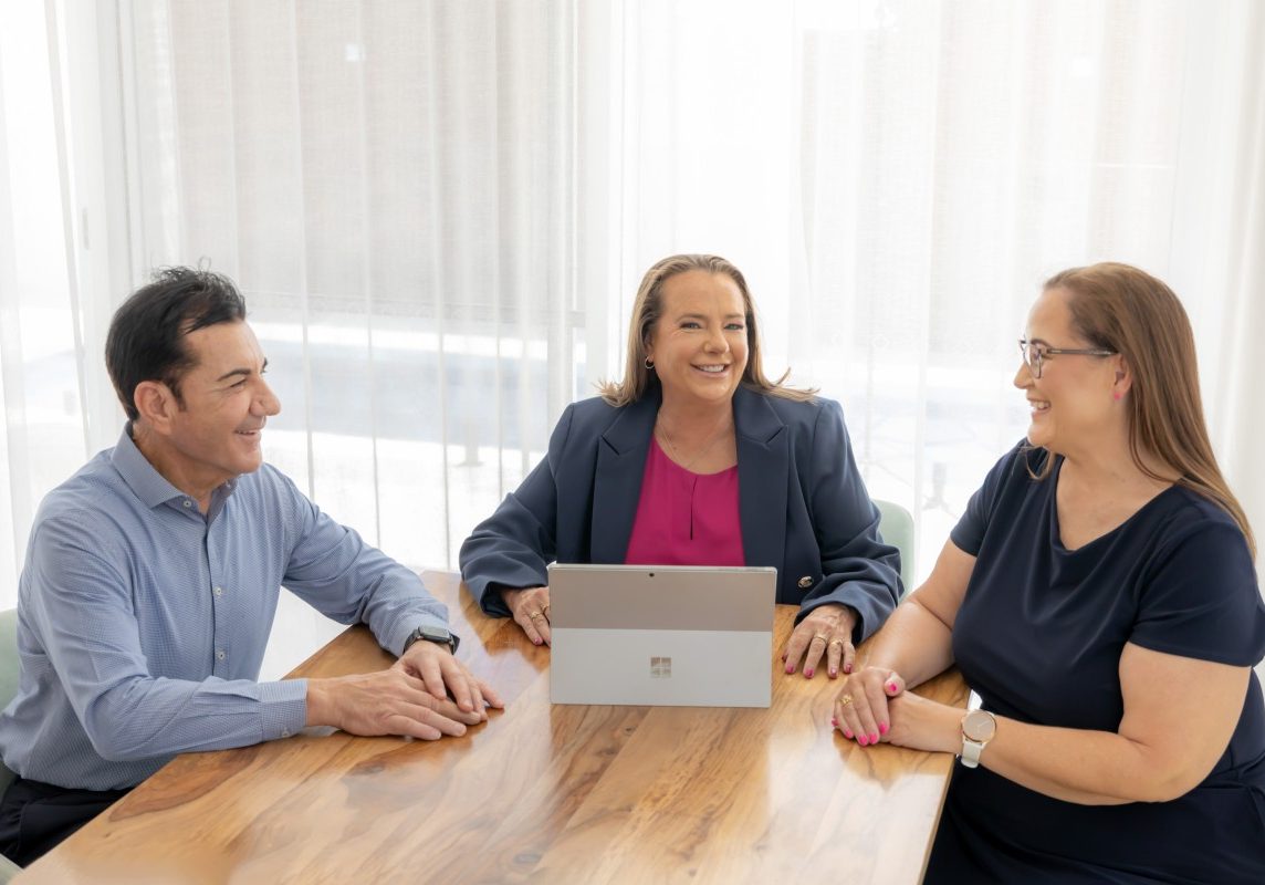 Perth Strata Co team discussing scheme management in the office